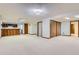 Finished basement with a bar area, ample space for entertaining, and multiple access doors at 7946 S Pennsylvania Ct, Littleton, CO 80122