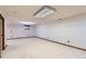 Spacious basement with neutral carpet and walls, offering a blank canvas for customization at 7946 S Pennsylvania Ct, Littleton, CO 80122