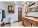 Classic bathroom with wooden cabinets, a toilet, and vintage fixtures for a traditional look at 7946 S Pennsylvania Ct, Littleton, CO 80122