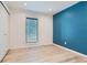 Bright bedroom featuring wood floors, accent wall, and plenty of natural light at 7946 S Pennsylvania Ct, Littleton, CO 80122