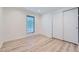 Bedroom featuring neutral walls, light wood floors, and a double-door closet at 7946 S Pennsylvania Ct, Littleton, CO 80122