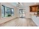 Bright dining area features stylish flooring, a large window, sliding glass doors, and built-in cabinetry at 7946 S Pennsylvania Ct, Littleton, CO 80122