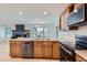 Bright kitchen features stainless steel appliances, granite countertops, and an open concept to the living area at 7946 S Pennsylvania Ct, Littleton, CO 80122