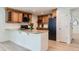 Well-equipped kitchen featuring an island with granite countertops, wooden cabinets, and modern appliances at 7946 S Pennsylvania Ct, Littleton, CO 80122