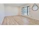 Bright and spacious living room featuring hardwood floors, and natural light from a large window at 7946 S Pennsylvania Ct, Littleton, CO 80122
