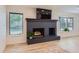 Living room with a modern fireplace, sleek flooring, and sun-filled windows create an inviting space at 7946 S Pennsylvania Ct, Littleton, CO 80122