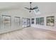 Inviting sunroom with lots of natural light from the many windows and sliding glass door at 7946 S Pennsylvania Ct, Littleton, CO 80122
