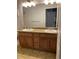 Bathroom featuring dual sinks in a classic vanity with plenty of counter space at 10457 W Hampden Ave # 104, Lakewood, CO 80227