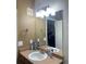 Bathroom with neutral toned wall, countertop, mirror, and chrome fixtures at 10457 W Hampden Ave # 104, Lakewood, CO 80227