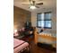 Cozy bedroom featuring unique wood accent wall, dark wood floors, and bright natural light at 10457 W Hampden Ave # 104, Lakewood, CO 80227