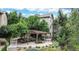 Community courtyard area featuring a pergola, stone walkways, and lush foliage at 10457 W Hampden Ave # 104, Lakewood, CO 80227