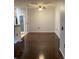 Spacious dining area with dark wood floors, contemporary lighting, and a pantry providing a versatile entertaining space at 10457 W Hampden Ave # 104, Lakewood, CO 80227
