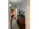 Hallway featuring a built-in desk area with storage, leading to a brightly lit bedroom at 10457 W Hampden Ave # 104, Lakewood, CO 80227