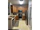 Updated kitchen featuring stainless steel appliances, wooden cabinets, and a convenient pantry door at 10457 W Hampden Ave # 104, Lakewood, CO 80227