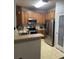 Well-lit kitchen with stainless steel appliances and ample cabinet space and a pantry at 10457 W Hampden Ave # 104, Lakewood, CO 80227
