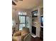 Comfortable living room with fireplace, chair, and access to the outdoor patio at 10457 W Hampden Ave # 104, Lakewood, CO 80227