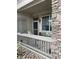 Cozy covered patio with stone accents and outdoor seating, perfect for relaxing at 10457 W Hampden Ave # 104, Lakewood, CO 80227