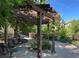 Tranquil pergola in a green common area with shady seating at 10457 W Hampden Ave # 104, Lakewood, CO 80227