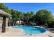Community pool featuring lots of lounge chairs and mature trees at 10457 W Hampden Ave # 104, Lakewood, CO 80227
