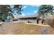 Spacious backyard featuring a brick house, shed, and a wooden fence, perfect for outdoor activities and relaxation at 3064 S Holly Pl, Denver, CO 80222