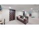 Spacious basement with comfortable seating, accent pillows, and ample room for recreation at 3064 S Holly Pl, Denver, CO 80222
