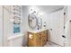 Modern bathroom with a double vanity, updated fixtures, and plenty of storage at 3064 S Holly Pl, Denver, CO 80222