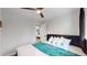 Bedroom with a ceiling fan, comfortable bed, and open door at 3064 S Holly Pl, Denver, CO 80222