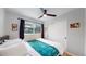 Cozy bedroom with a ceiling fan, natural light, and closet at 3064 S Holly Pl, Denver, CO 80222