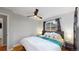 Bedroom with a ceiling fan, bedside table and bright window at 3064 S Holly Pl, Denver, CO 80222