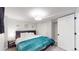Well-lit bedroom featuring a comfortable bed, closet, and soft, neutral tones at 3064 S Holly Pl, Denver, CO 80222