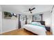 Bedroom with hardwood floors, TV, and bright natural light at 3064 S Holly Pl, Denver, CO 80222