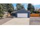 Charming blue home with a two-car garage and well-maintained front yard at 3064 S Holly Pl, Denver, CO 80222