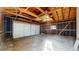 Spacious garage with exposed wood ceiling beams, ready for storage or projects at 3064 S Holly Pl, Denver, CO 80222