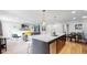 Stylish kitchen island with bar seating and views into the living room at 3064 S Holly Pl, Denver, CO 80222