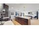 Modern kitchen with pendant lighting, stainless appliances and open floor plan at 3064 S Holly Pl, Denver, CO 80222