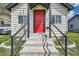Close-up of a home's red front door with black trim and concrete steps at 1746 Galena St, Aurora, CO 80010