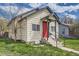 Charming bungalow-style home with a red front door, black trim, and green lawn at 1746 Galena St, Aurora, CO 80010