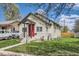 Inviting home with a red door, well-kept lawn, and mature trees at 1746 Galena St, Aurora, CO 80010
