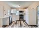 Well-lit kitchen equipped with stainless steel appliances, white cabinetry and light countertops at 1746 Galena St, Aurora, CO 80010