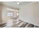 Neutral living room with modern flooring offers views into the entry and other rooms at 1746 Galena St, Aurora, CO 80010
