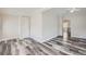 Open living space with wood-look floors, neutral walls, and views into other rooms at 1746 Galena St, Aurora, CO 80010