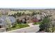 Expansive aerial view of a home with well-manicured lawn, three-car garage, and proximity to open spaces at 14820 E Maplewood Dr, Centennial, CO 80016