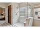 Elegant bathroom showcasing a glass-enclosed shower with marble walls and stylish finishes at 14820 E Maplewood Dr, Centennial, CO 80016
