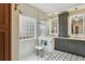 Modern bathroom with a glass shower, sleek fixtures, and decorative tile flooring at 14820 E Maplewood Dr, Centennial, CO 80016