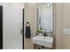 Modern bathroom featuring a floating sink, lighted mirror, and stylish fixtures at 14820 E Maplewood Dr, Centennial, CO 80016