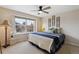 Well-lit bedroom showcasing a plush bed, decorative wall art, and natural light at 14820 E Maplewood Dr, Centennial, CO 80016