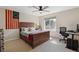 Comfortable bedroom featuring a wooden bed frame, ceiling fan, and a dedicated desk area at 14820 E Maplewood Dr, Centennial, CO 80016