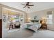 Bright bedroom features large windows, a comfortable chair and decorative accents at 14820 E Maplewood Dr, Centennial, CO 80016