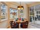 Cozy breakfast nook with large windows and sliding glass door to the outdoor area at 14820 E Maplewood Dr, Centennial, CO 80016
