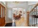 Elegant dining room featuring hardwood floors, a large window, and an open transition to the kitchen at 14820 E Maplewood Dr, Centennial, CO 80016